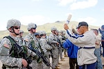 Oregon National Guard Soldiers, from B Company, 2nd Battalion, 162nd Infantry, Sgt. Brandon Hern (left), of Corvallis, and Pvt. 1st Class Geoffery Thoma (right), of Albany, simulate controlling a crowd of a villagers at a food distribution site during Distribution training Aug. 16, at Five Hills Training Center, near Ulan Bator, Mongolia, for Khaan Quest 2006, UN peacekeeping exercise.