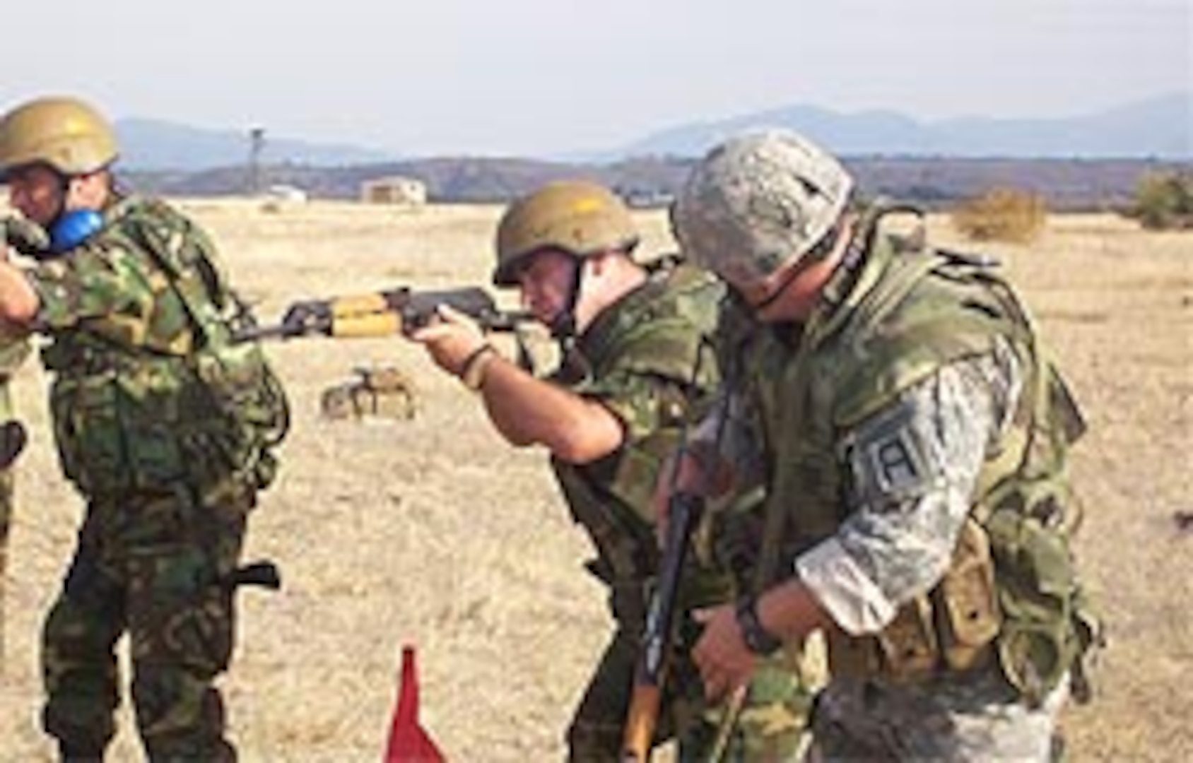 A Vermont National Guardsman observes a Macedonian military policeman during the rifle marksmanship training portion of Operation Rising Phalanx, which took place here Sept. 9-22, 2006. The U.S. European Command State Partnership Program sponsored field exercise culminated a 10-month small unit exchange to train Macedonian Army military police platoons to take part in international peacekeeping missions. The State Partnership Program, which originated in 1993, links a National Guard State with a partner nation in support of EUCOM's Theater Security Cooperation objectives. There are currently 24 partnerships within the EUCOM area of responsibility.