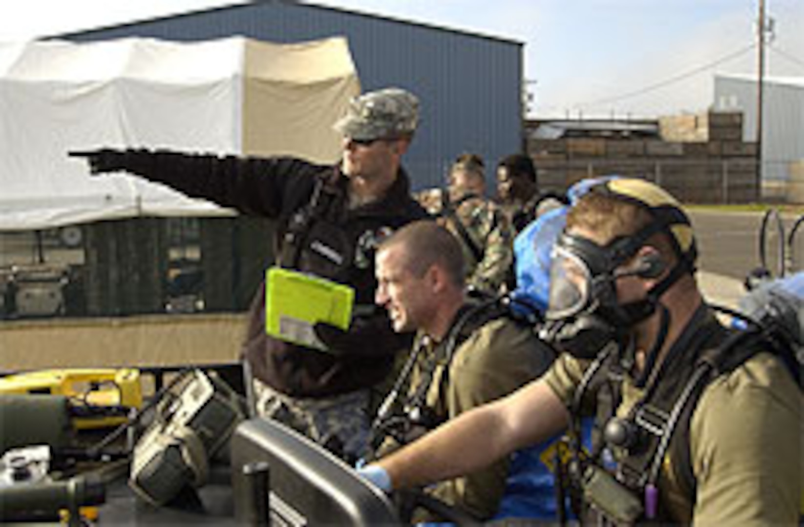 Sgt. Chris Campbell, (left), of the 102nd Civil Support Team, briefs Sgt. Richard Hosmer (center), and Sgt. Paul Edgerly (right), both CST Survey Team Members, at a CST demonstration event at the Marion County Regional Fire Training Facility in Brooks, Ore., on Oct. 27, 2006. Staff Sgt. John Reyes, Survey Team Chief & Sgt 1st Class Sharon Robertson, Logistics NCO, are in the background.