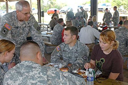 Maj. Gen. Ron Chastain, the adjutant general of the Arkansas National Guard, visits with Soldiers and their families during a going away celebration on Monday at Camp Shelby, Miss. Family members and Guard leaders gathered at Camp Shelby to bid farewell to the Soldiers, who were deploying with Company D, 1st Battalion, 114th Aviation (Air Traffic Services) of the 77th Aviation Brigade. Over 60 Soldiers strong, the unit departed Camp Shelby, Miss, on Tuesday, Oct. 31, 2006, for their yearlong deployment in Iraq.