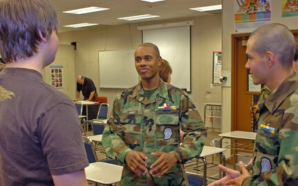 Joesph Hardy and another cadet explain the challenges of the six-month resident youth course to a prospective applicant.