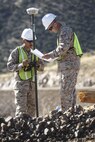 U.S. Marine surveyors and drafters Cpl. Joe Sabun and Lance Cpl. Gill Aluna, assigned to Engineer Company, Marine Wing Support Squadron 272, Marine Corps Air Station New River, N.C., use a GPS-based surveying tool to mark exactly where the Marines need to add or remove material to create a new border road, near Nogales, Ariz., Mar. 19.

