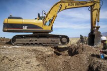 U.S. Marines assigned to Engineer Company, Marine Wing Support Squadron 272, Marine Corps Air Station New River, N.C., use an excavator to dig a trench for a new culvert designed to protect a recently constructed border road near Nogales, Ariz., Mar. 19.