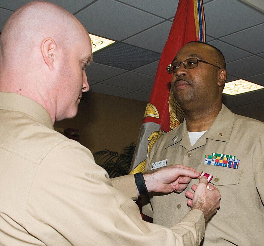 Navy Lt. Kenneth L. Miller, chaplain, Marine Corps Logistics Base Albany, receives a Meritorious Service Medal from Lt. Col. Daniel Bates, executive officer, MCLB Albany, during his retirement ceremony at the Town and Country Ballroom, March 8. Miller has two decades of combined military service from the Air Force and Navy.