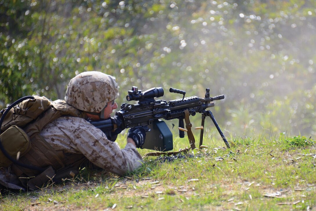A reconnaissance man engages unknown-distance targets with an M249 squad automatic weapon March 25 at Range 10 near Camp Schwab during weapons familiarization and sustainment training. Marines trained with a variety of weapons during different firing scenarios, along with conducting immediate and remedial action drills designed to train the Marines to respond instinctively to firing stoppages or weapons malfunctions. The reconnaissance man is with 3rd Reconnaissance Battalion, 3rd Marine Division, III Marine Expeditionary Force. 