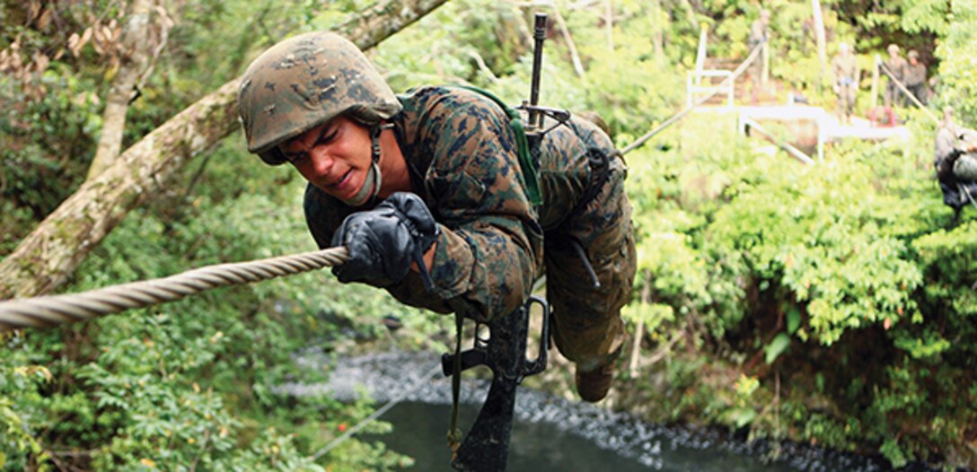Cpl. Wilkins Vidal crosses the monkey crawl obstacle of the endurance course March 21 at the Jungle Warfare Training Center on Camp Gonsalves during the Headquarters and Service Battalion, Marine Corps Base Camp Smedley D. Butler corporals’ course. Throughout the endurance course, Marines were required to cross numerous natural and man-made obstacles. Vidal is the training noncommissioned officer for Company B, H&S Bn., MCB Camp Butler, Marine Corps Installations Pacific. 