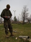Corporal Steven B. Dungan, Combat Engineer assigned to Combat Logistics Battalion (CLB) 26, 26th Marine Expeditionary Unit (MEU), sets up a mock improvised explosive device (IED), during a counter-IED training exercise, Vaziani Airbase, Republic of Georgia, during exercise Agile Spirit 13, March 23, 2013. The 26th MEU is deploying to the 5th and 6th Fleets area of operations. The 26th MEU operates continuously across the globe, providing the president and unified combatant commanders with a forward-deployed, sea-based quick reaction force. The MEU is a Marine Air-Ground Task Force capable of conducting amphibious operations, crisis response and limited contingency operations. (U.S. Marine Corps motion media by Lance Cpl. Juanenrique Owings/Released)