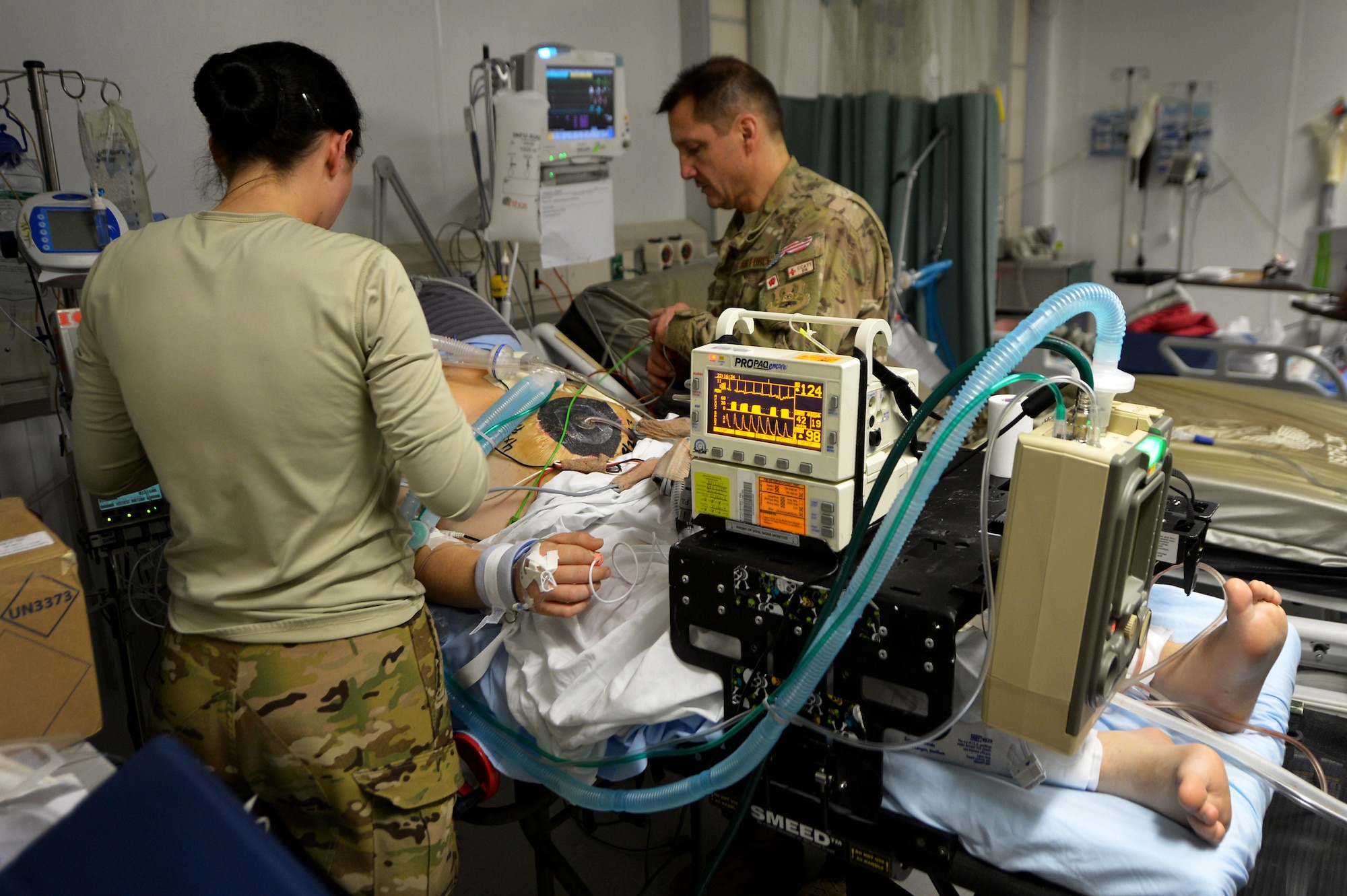 Capt. Suzanne Morris and Maj. Michael Mackovich, 455th Expeditionary Aeromedical Evacuation Squadron Critical Care Air Transport Team nurses, connect a patient to CCATT medical equipment at Bagram Airfield, Afghanistan, March 21, 2013. A CCATT crew consists of a physician, intensive care nurse and a respiratory therapist, making it possible to move severely injured or gravely ill servicemembers by air.  (U.S. Air Force photo/Senior Airman Chris Willis)