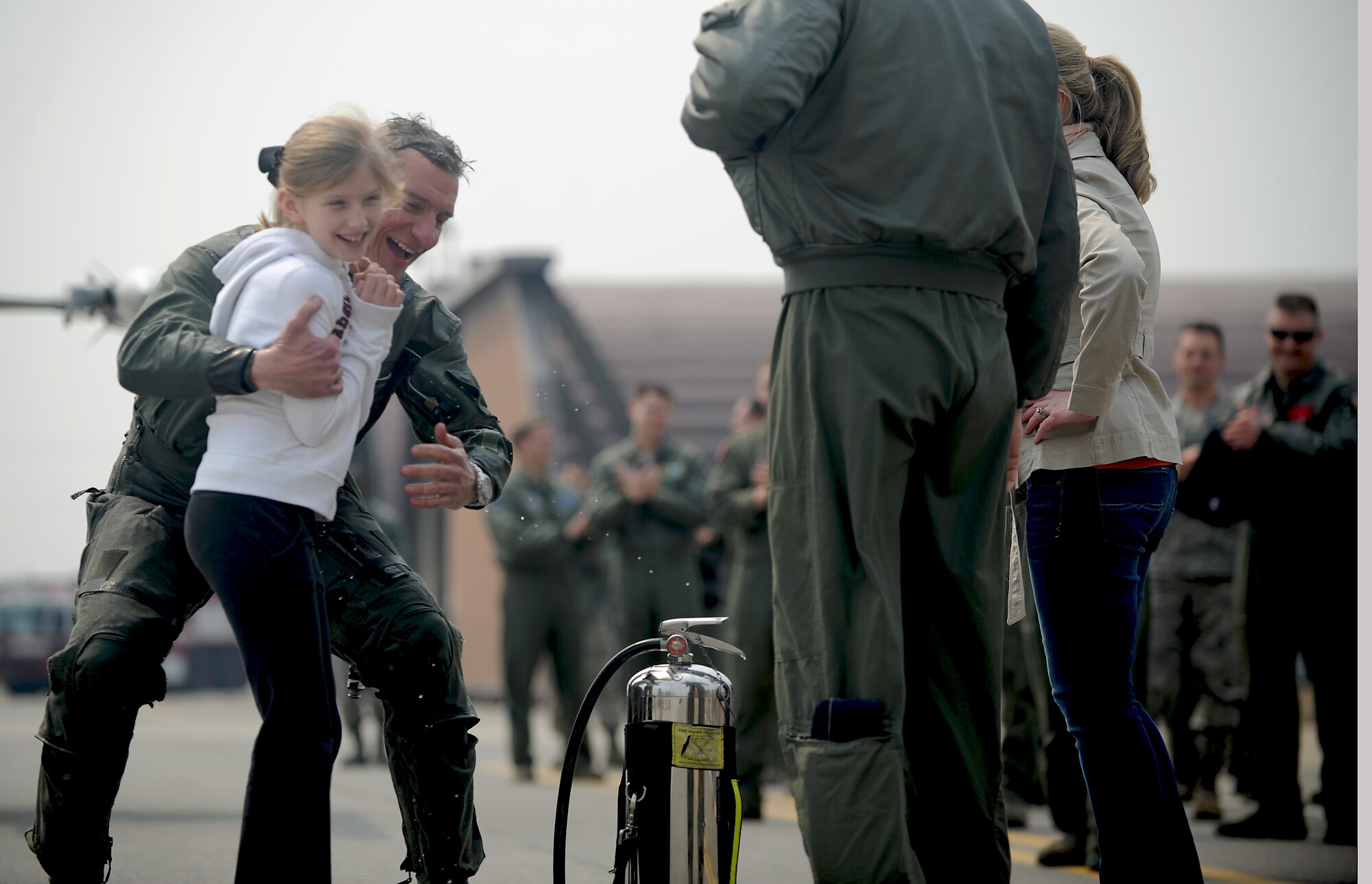Col. Patrick McKenzie, 51st Fighter Wing commander, hugs his daughter after  reaching 3,000 flying hours in an F-16 Fighting Falcon at Osan Air Base, Republic of Korea, March 28, 2013. Only a little more than 200 F-16 pilots worldwide are documented as sharing this 3,000-hour achievement. (U.S. Air Force photo/Staff Sgt. Sara Csurilla) 
