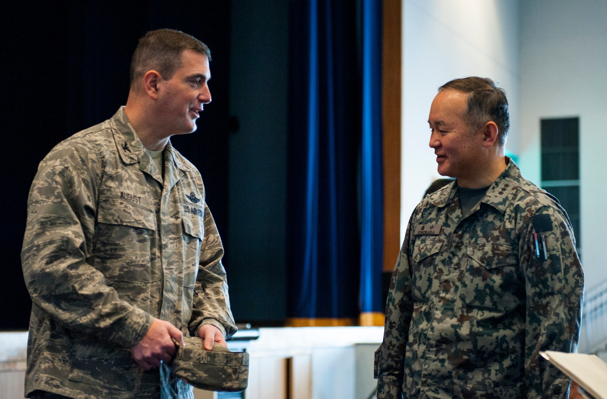 Col. Mark August, 374th Airlift Wing commander, and Japan Air Self-Defense Force Lt. Gen. Masayuki Hironaka, Air Support Command commander, talk after the general's observation of a simulated noncombatant evacuation operation at Yokota Air Base, Japan, March 28, 2013.  Yokota service members showcased their NEO capabilities in an effort to strengthen bilateral relations with JASDF counterparts. August expressed the importance of joint participation between Yokota and JASDF in future NEO exercises. (U.S. Air Force photo by Senior Airman Cody H. Ramirez)