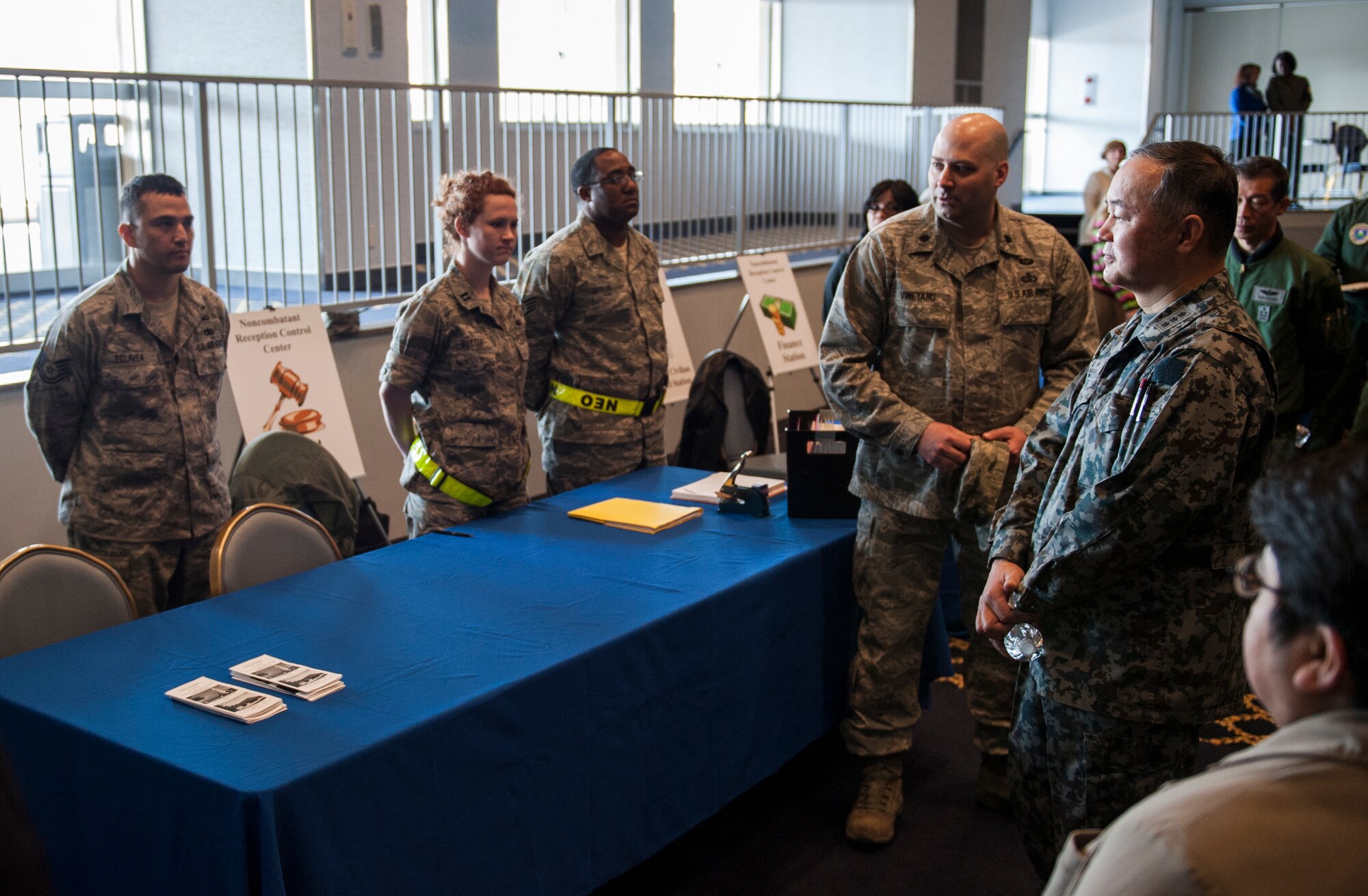 Japan Air Self-Defense Force Lt. Gen. Masayuki Hironaka, Air Support Command commander, speaks with chaplain services at a simulated noncombatant evacuation operation at the Taiyo Recreation Center at Yokota Air Base, Japan, March 28, 2013.  During an NEO many service units throughout the base gather at one location to assist those who are in emergency transition. Yokota service members showcased their NEO capabilities in an effort to strengthen bilateral capability with JASDF counterparts. (U.S. Air Force photo by Senior Airman Cody H. Ramirez)