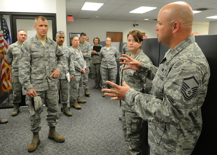 Master Sgt. Bryan Rock, 15th Maintenance Operations Squadron superintendent (right), explains his section’s mission objectives to Pacific Air Forces Command Chief, Chief Master Sgt. Steve McDonald, during a tour of the 15th Maintenance Group, Joint Base Pearl Harbor-Hickam, Hawaii, March 27, 2013. McDonald visited various facilities at the 15th Wing during his tour to gain a better understanding of the Wing’s mission and resources. (U.S. Air Force photo/Tech. Sgt. Jerome S. Tayborn)