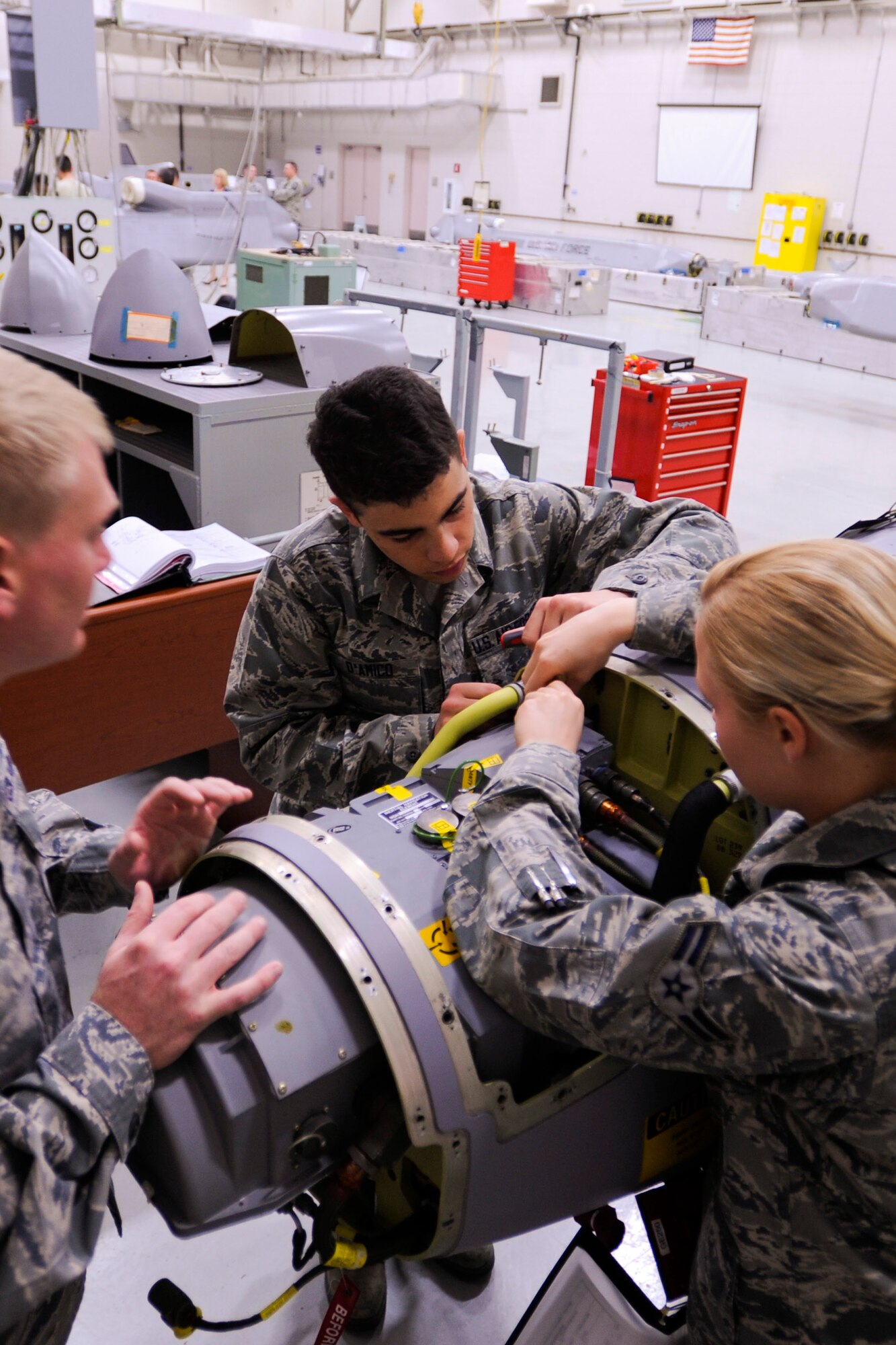 VANDENBERG AIR FORCE BASE, Calif. -- Students from the 532nd Training Squadron work on an Air Launch Cruise Missile Simulator in their training facility here Wednesday, March 27, 2013. The squadron recently received four of the simulators from Tinker Air Force Base, Okla. to replace the old “worn-out” ones and provide a more realistic training environment.  (U.S. Air Force photo/Airman Yvonne Morales) 