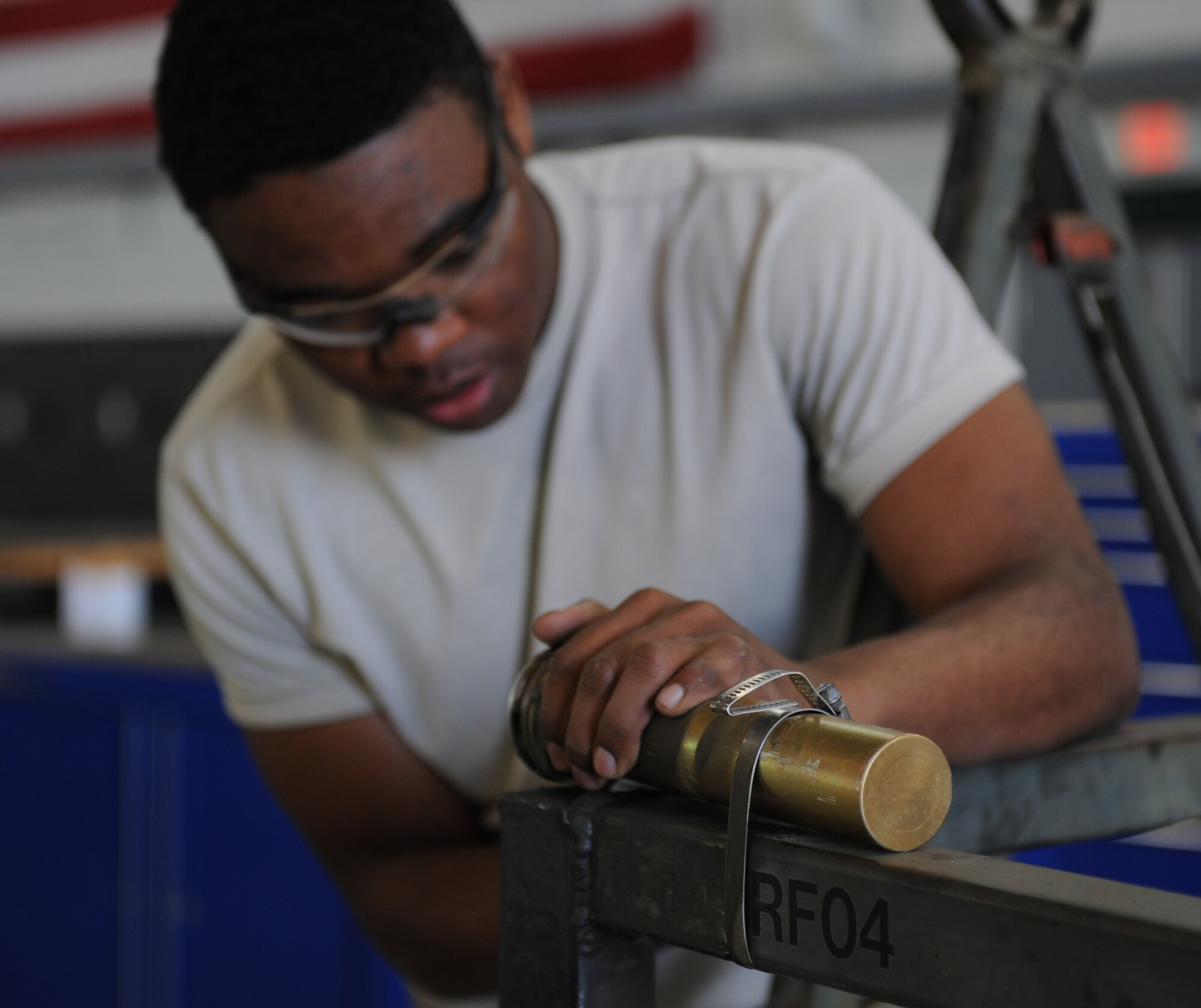 Airman 1st Class Antonio Simon, 2nd Maintenance Squadron Aerospace Ground Equipment flight, replaces reflective tape from a run fence on Barksdale Air Force Base, La., March 28. In order to prevent mishaps in the hours of darkness, reflective tape is placed on all equipment. (U.S. Air Force photo/Airman 1st Class Benjamin Gonsier)
