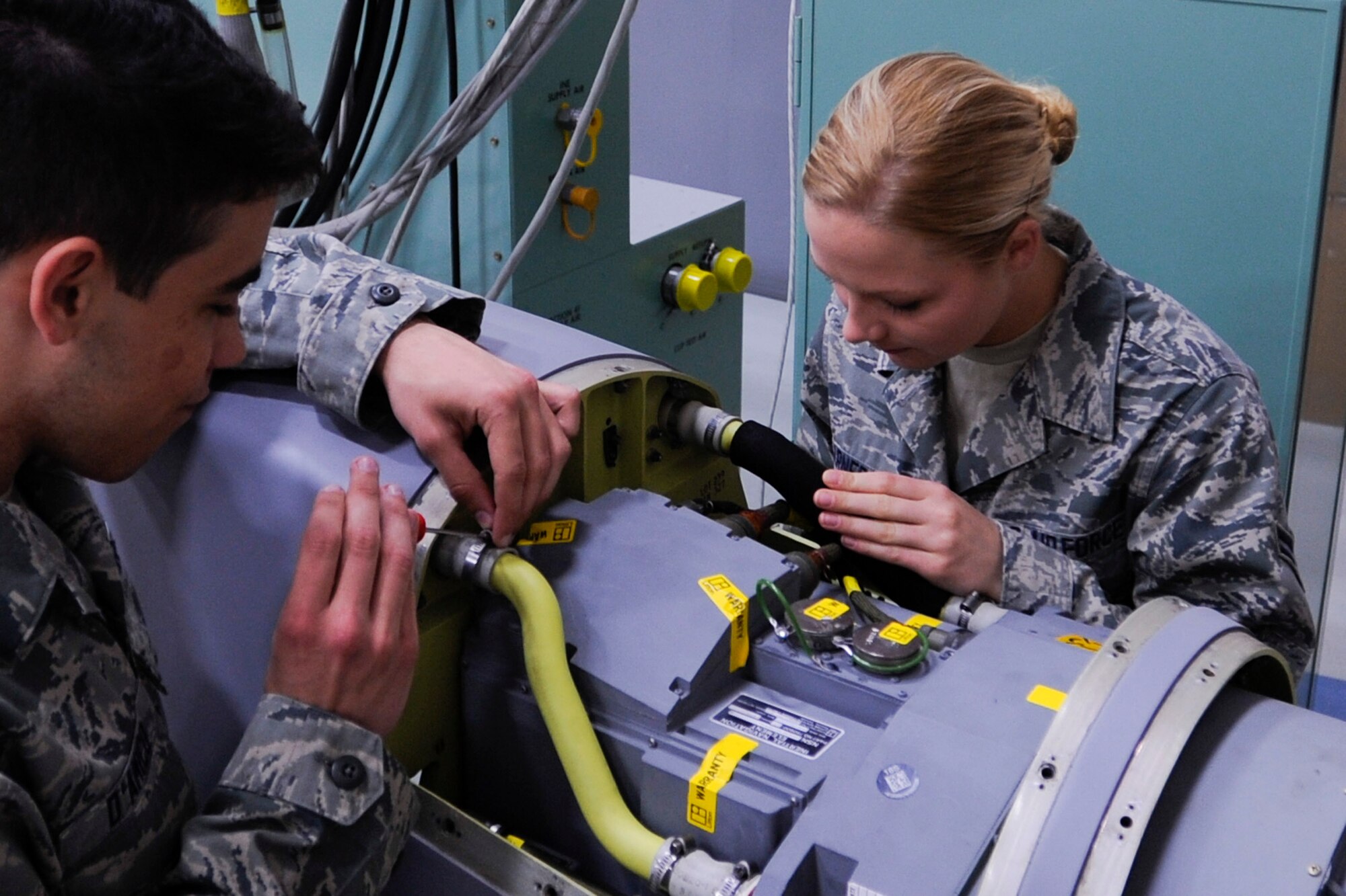 VANDENBERG AIR FORCE BASE, Calif. -- Students from the 532nd Training Squadron work on an Air Launch Cruise Missile Simulator in their training facility here Wednesday, March 27, 2013. The squadron recently received four of the simulators from Tinker Air Force Base, Okla. to replace the old “worn-out” ones and provide a more realistic training environment.  (U.S. Air Force photo/Airman Yvonne Morales) 