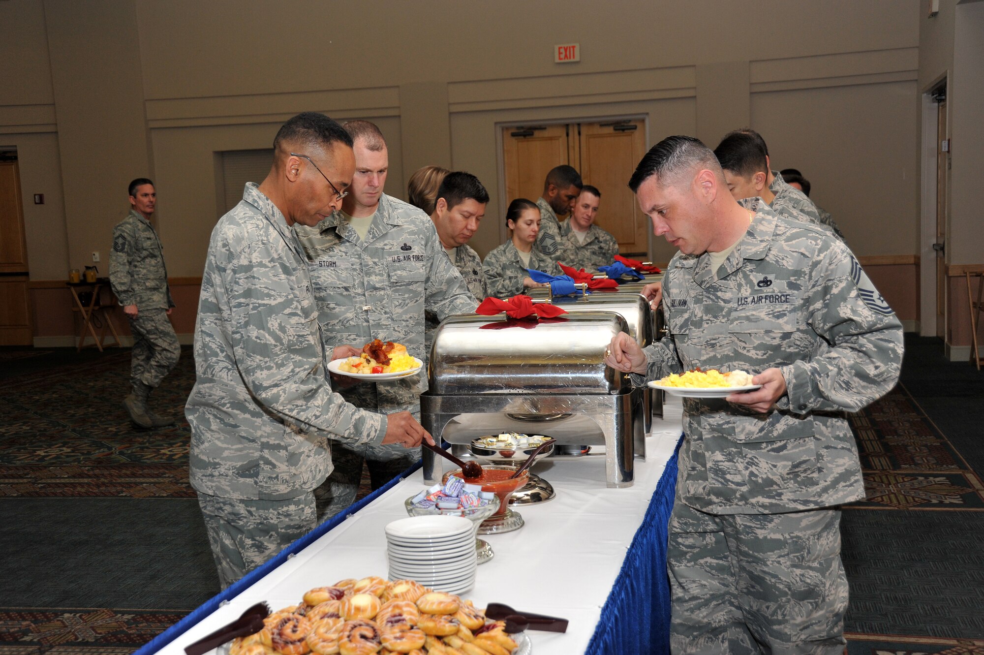 Lackland senior leaders and key workers participating in the AFAF program enjoy a hearty breakfast during a gathering to celebrate the program’s kickoff. (U.S. Air Force photo by Alan Boedeker/Released)