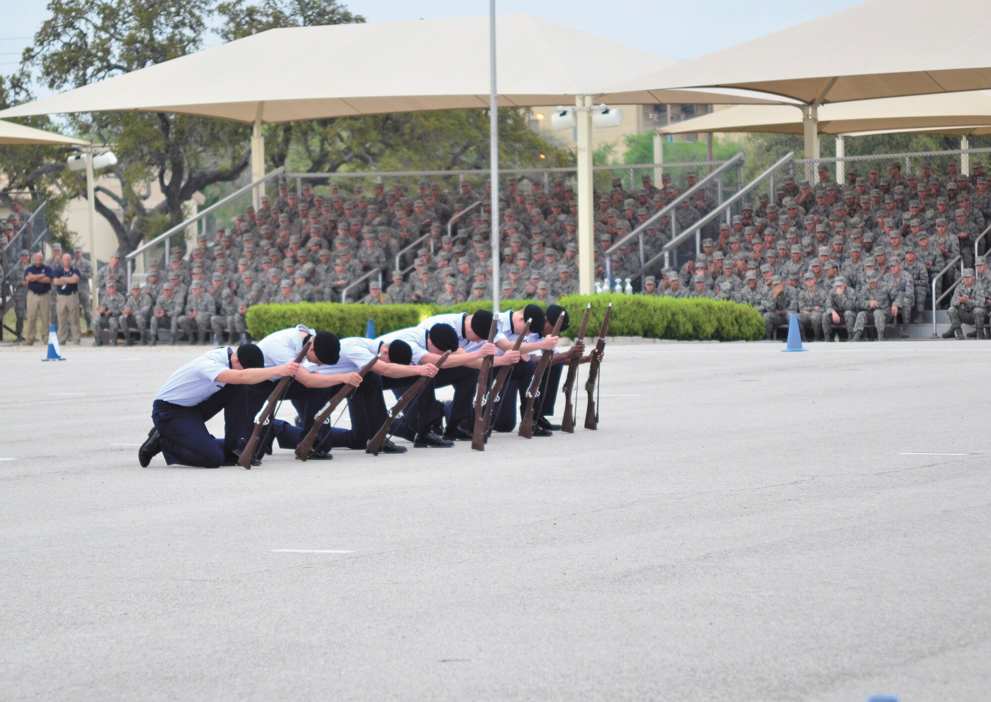 Airmen from the 342rd Training Squadron exhibition weapons team report in for permission to enter the field of competition at the 37th Training Group quarterly drill down at JBSA-Lackland. (U.S. Air Force photo by Airman Peter McNair/Released)