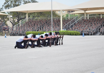 Airmen from the 342rd Training Squadron exhibition weapons team report in for permission to enter the field of competition at the 37th Training Group quarterly drill down at JBSA-Lackland. (U.S. Air Force photo by Airman Peter McNair/Released)
