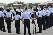 Members of the 343rd Training Squadron drill team gather for a moment of reflection prior to the 37th Training group drill competition at JBSA-Lackland.  (U.S. Air Force photo by Airman Peter McNair/Released)