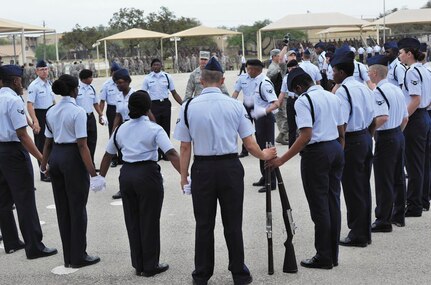 Members of the 343rd Training Squadron drill team gather for a moment of reflection prior to the 37th Training group drill competition at JBSA-Lackland.  (U.S. Air Force photo by Airman Peter McNair/Released)
