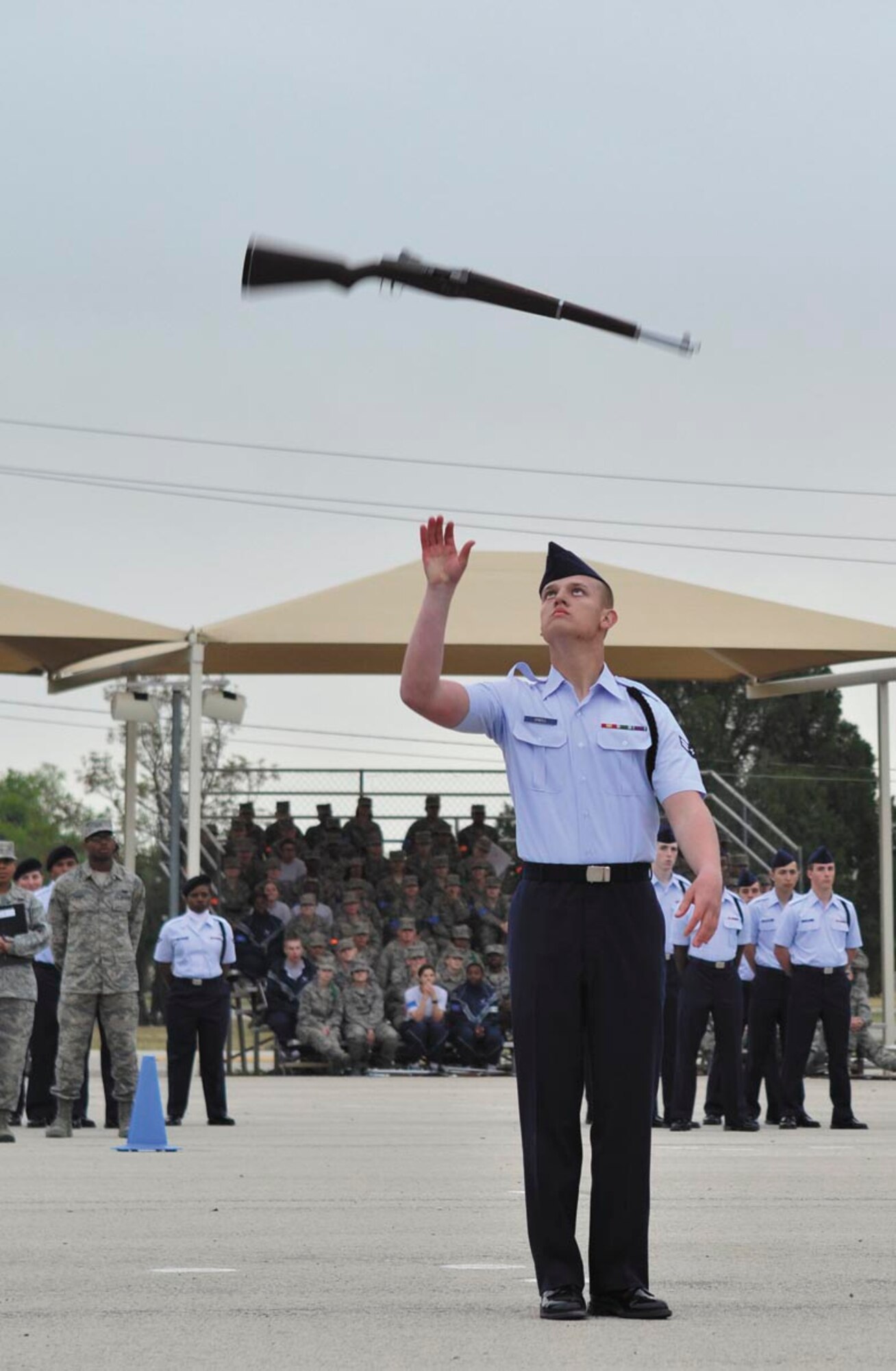 Airman First Class John O'Neill, 343rd Training Squadron exhibition weapons drill leader, displays his individual rifle spin ability at the 37th Training Group drill competition at JBSA-Lackland. (U.S. Air Force photo by Airman Peter McNair/Released)