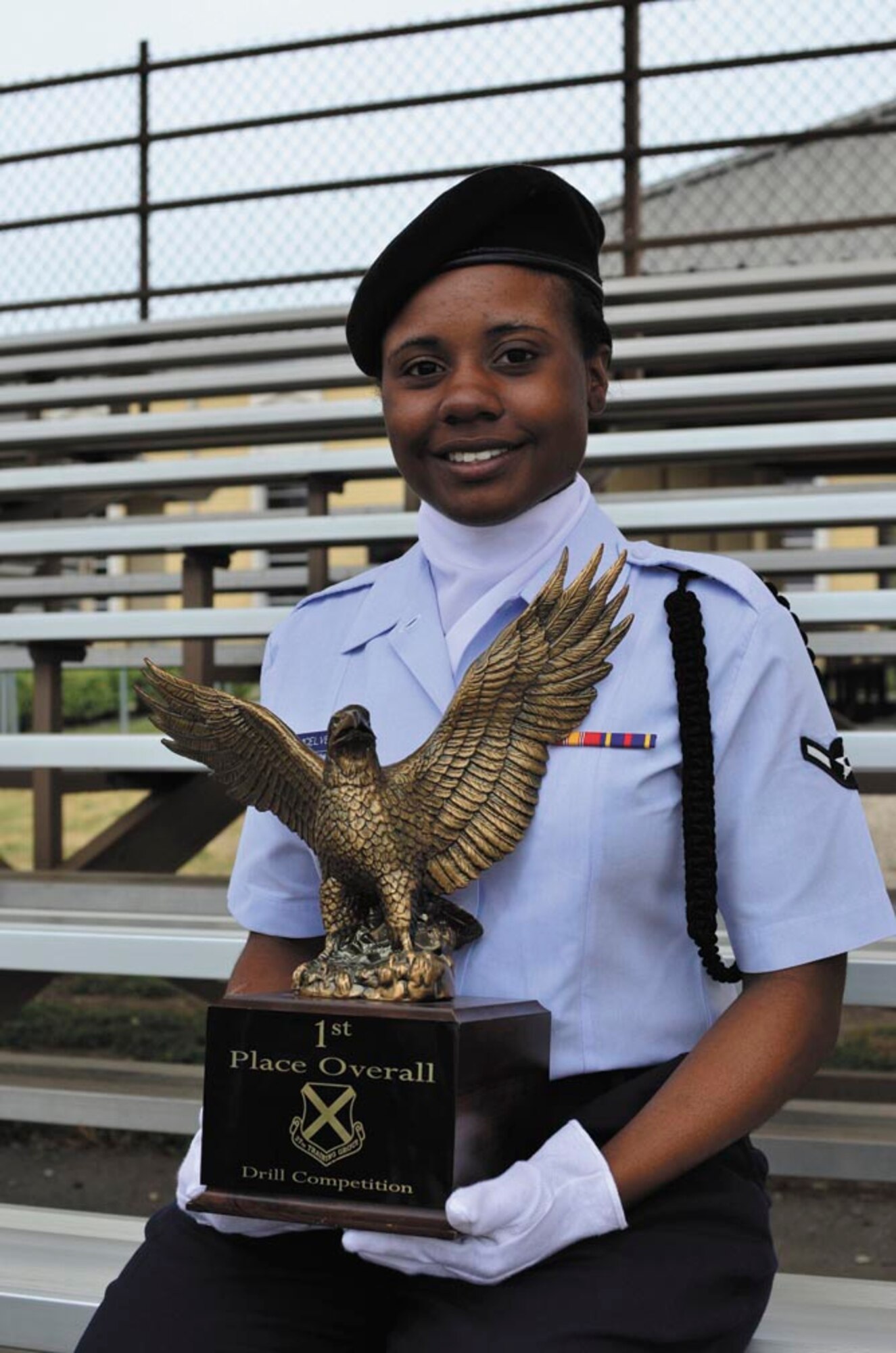 Airman Shakira McElveen, team drill commander, shows off the overall first place trophy won by the 343rd Training Squadron at the 37th Training Group quarterly drill competition, JBSA-Lackland. (U.S. Air Force photo by Airman Peter McNair/Released)
