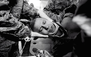 Medical technicians and doctors turn an Airman with simulated injuries on his side, as part of a training scenario Feb. 19, 2013  at Suwon Air Base, South Korea. (U.S. Air Force photo/Staff Sgt. Sara Csurilla)
