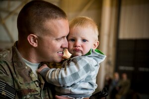 Airman 1st Class Alex Newport hugs his son, Jett, March 26, 2013, at Moody Air Force Base, Ga. Newport and approximately 350 Airmen left Moody AFB for a six-month deployment to Southwest Asia. Newport is assigned to the 74th Aircraft Maintenance Unit. (U.S. Air Force photo/Staff Sgt. Jamal D. Sutter) 