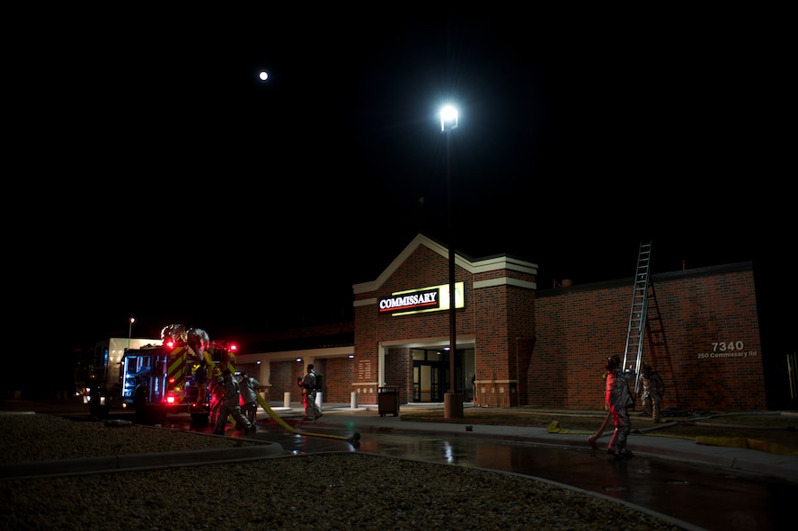 Dyess Air Force Base emergency responders and Abilene Fire Department clean up after fire at the base commissary, March 25, 2013, at Dyess Air Force Base, Texas. The fire was reported at approximately 5:30 p.m. and was extinguished by 6:30 p.m. About 30 Dyess firefighters and eight Abilene firefighters responded to the scene. All occupants of the building were evacuated safely and no injuries were reported. The cause of the fire is still under investigation. The commissary will reopen for business March 28 at 10 a.m. with limited access to some aisles. (U.S. Air Force photo by Staff Sgt. Richard P. Ebensberger/Released)