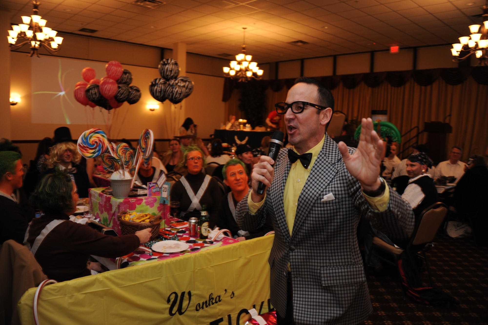 Lt. Col. David Searle, 87th Contracting Squadron commander, emcees the McGuire Officers Spouses Club Trivia Night March 22, 2013, in Tommy B’s Community Activities Center at Joint Base McGuire-Dix-Lakehurst, N.J. This was the third year of the competition, the proceeds of which go to the MOSC scholarship fund for military dependents. (U.S. Air Force photo by 2nd Lt. David J. Murphy/Released)