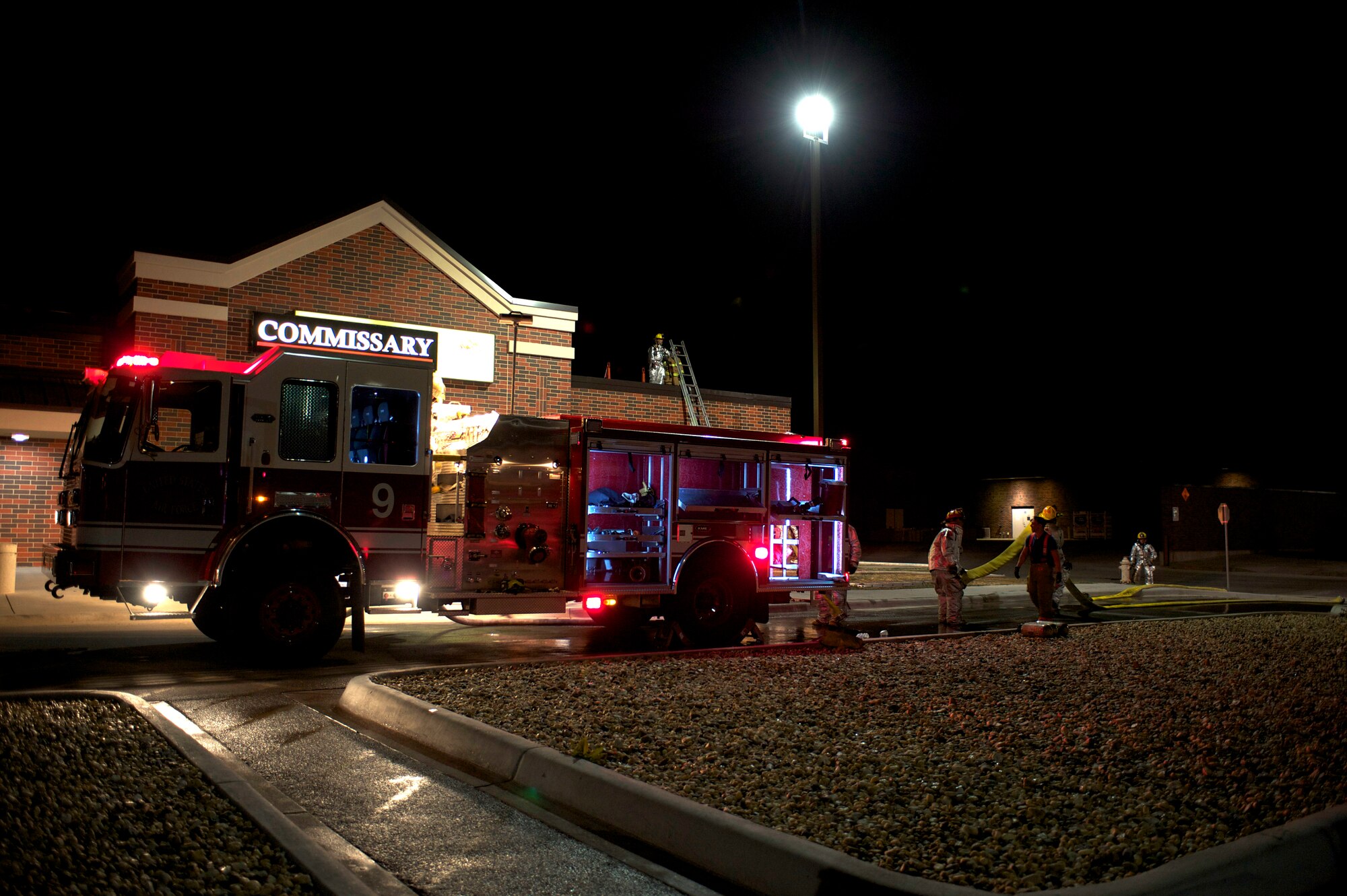 Dyess Air Force Base emergency responders and Abilene Fire Department clean up after fire at the base commissary, March 25, 2013, at Dyess Air Force Base, Texas. The fire was reported at approximately 5:30 p.m. and was extinguished by 6:30 p.m. About 30 Dyess firefighters and eight Abilene firefighters responded to the scene. All occupants of the building were evacuated safely and no injuries were reported. The cause of the fire is still under investigation. The commissary will reopen for business March 28 at 10 a.m. with limited access to some aisles. (U.S. Air Force photo by Staff Sgt. Richard P. Ebensberger/Released)