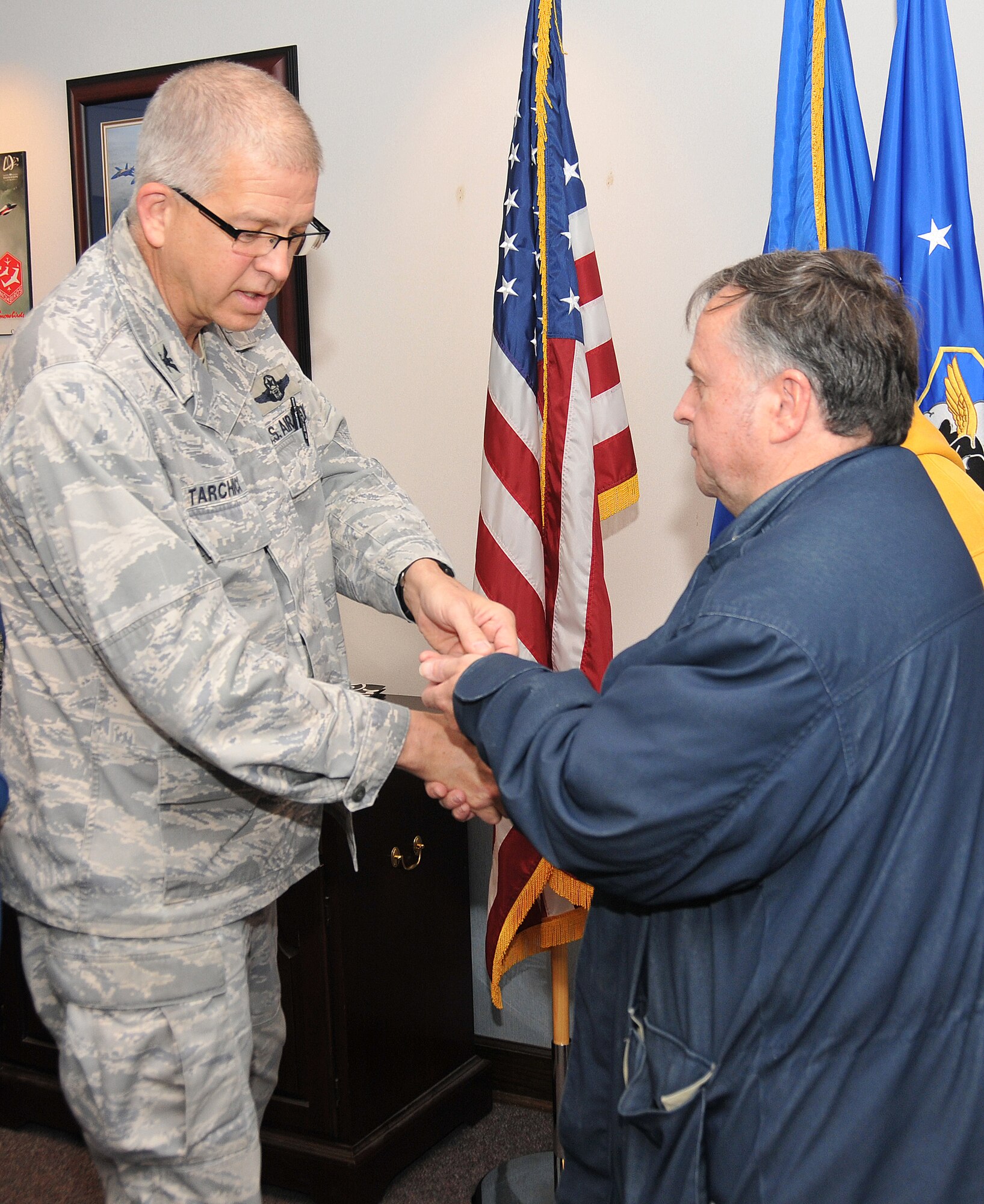 David Felix was honored by Tarchick with the “Lunch Pail” Award on March 28 at a wing staff meeting held in the 94th AW headquarters building. Felix also received a 94th AW commander’s coin for his dedicated service to the base. (U.S. Air Force photo/Senior Airman Elizabeth Van Patten)