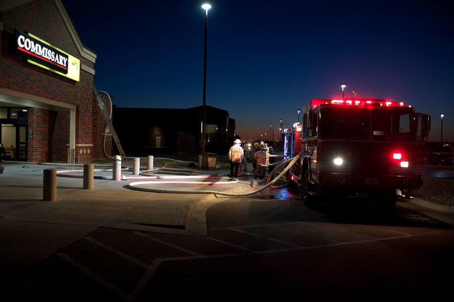 Dyess Air Force Base emergency responders and Abilene Fire Department respond to a fire at the base commissary March 25, 2013, at Dyess Air Force Base, Texas. The fire was reported at approximately 5:30 p.m. and was extinguished by 6:30 p.m. About 30 Dyess firefighters and eight Abilene firefighters responded to the scene. The cause of the fire is still under investigation. The commissary will reopen for business March 28 at 10 a.m. with limited access to some aisles. (U.S. Air Force photo by Staff Sgt. Richard P. Ebensberger/Released)