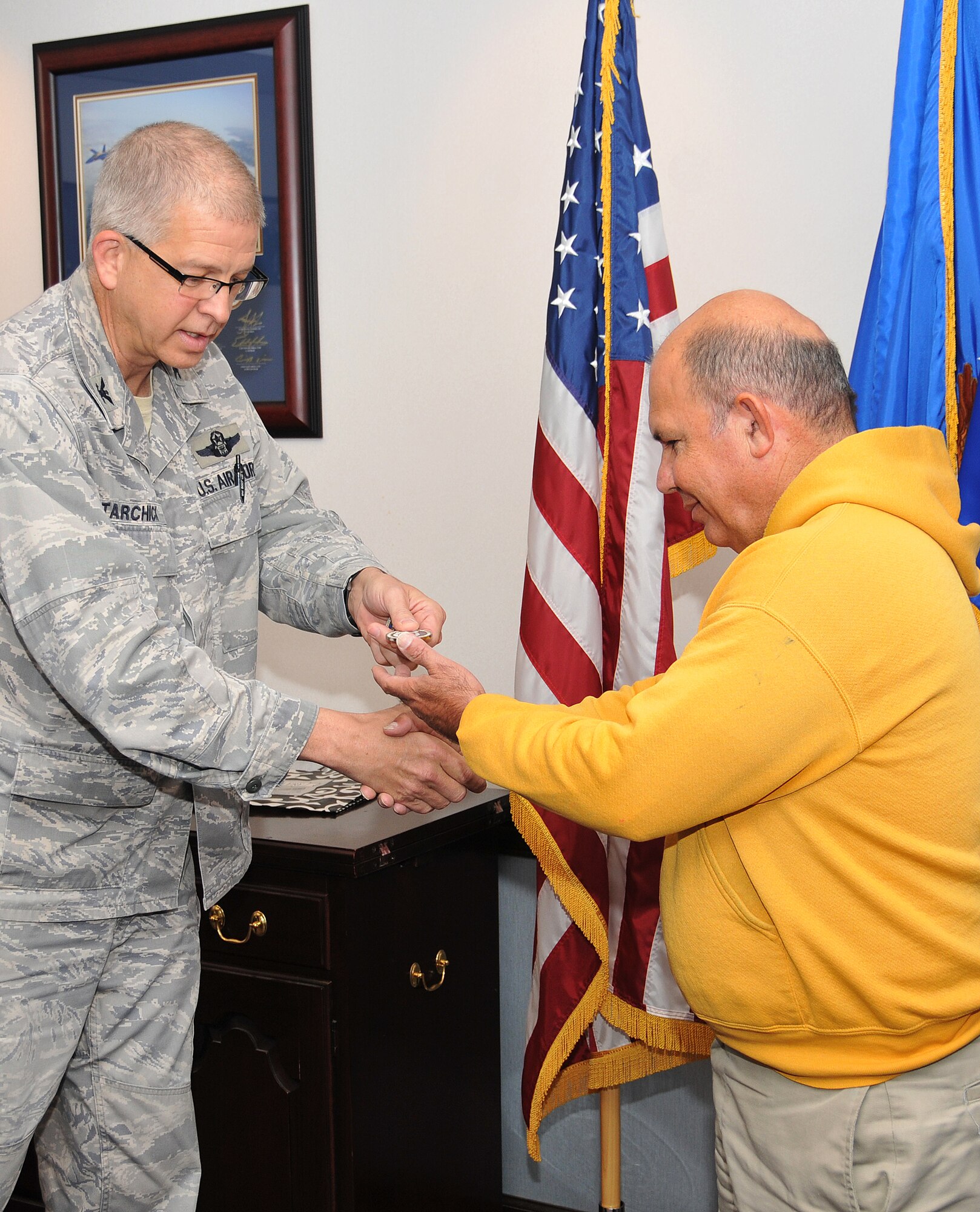 Ernest “Getting-it-done” Frame was honored by Tarchick with the “Lunch Pail” Award on March 28 at a wing staff meeting held in the 94th AW headquarters building. Frame also received a 94th AW commander’s coin for his dedicated service to the base. (U.S. Air Force photo/Senior Airman Elizabeth Van Patten)