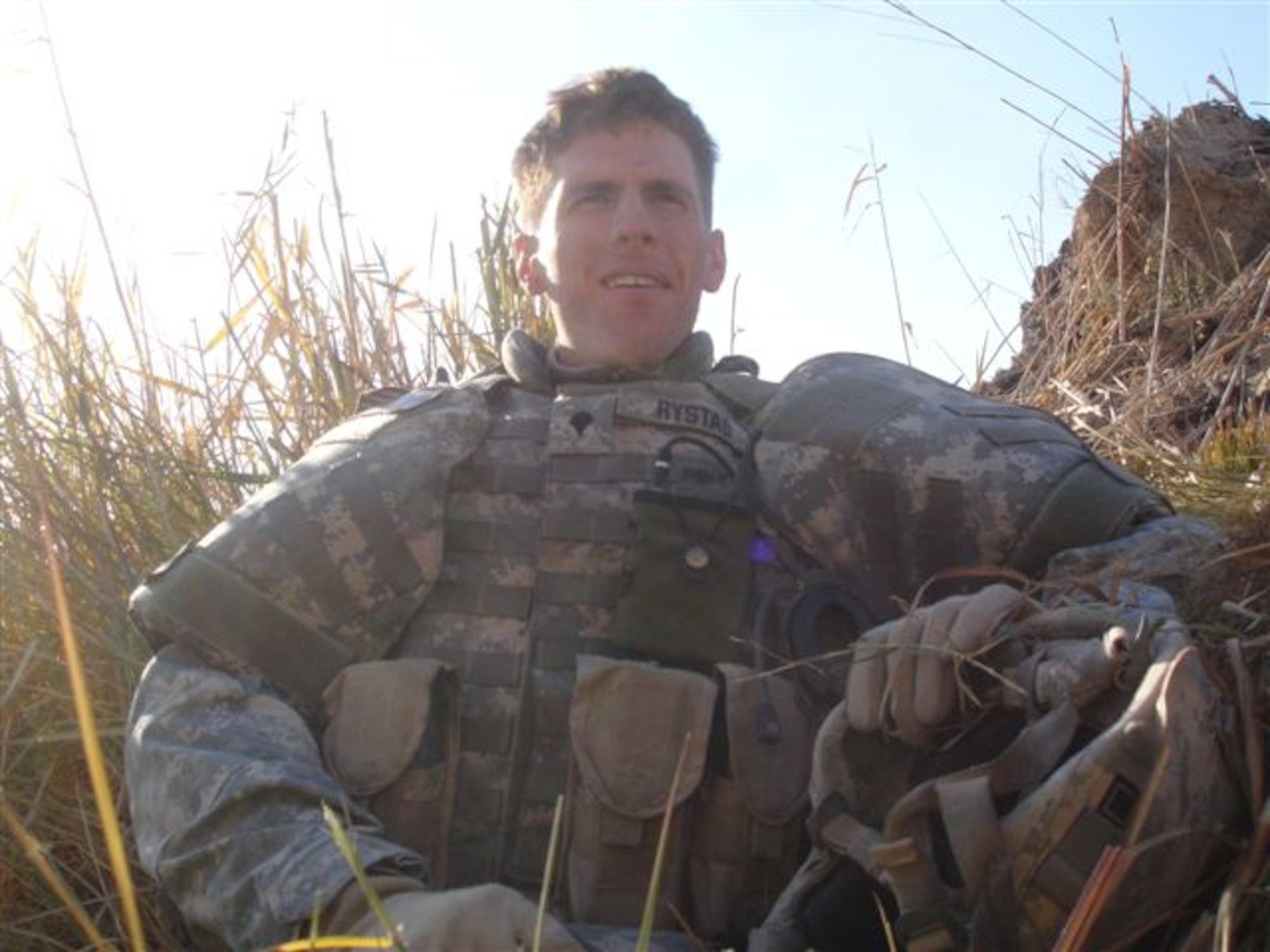 Pictured is Corey J. Rystad baring the rank of an Army specialist. Sgt. Rystad, age 20, of Red Lake Falls was killed in combat while traveling on a patrol mission near Fallujah, Iraq, after an improvised explosive device detonated near his vehicle on Dec. 2, 2006. His childhood friend from Red Lake Falls, Minn., Kurt Philion, honors his memory by carrying a 3 by 5 foot American flag while running races with a T-shirt bearing this image of him. (File photo courtesy of Minnesota National Guard)
