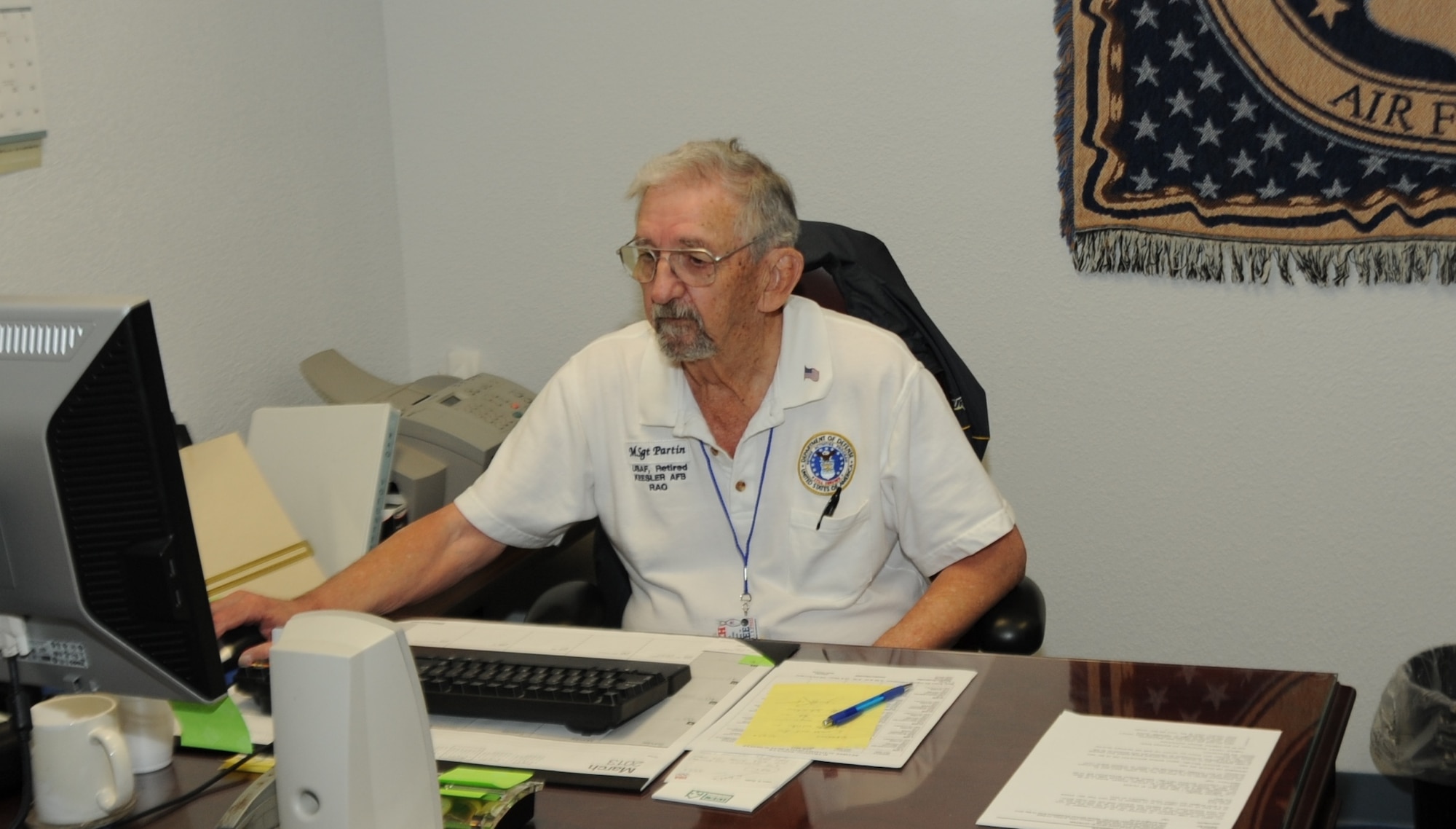 Retired Master Sgt. Charlie Partin checks his computer for updates March 25, 2013, at the Sablich Center, Keesler Air Force Base, Miss. Partin is the deputy director at the Retiree Activities Office, which helps thousands of veterans each year.  (U.S Air Force photo by 2nd Lt. Allanna Jones)  