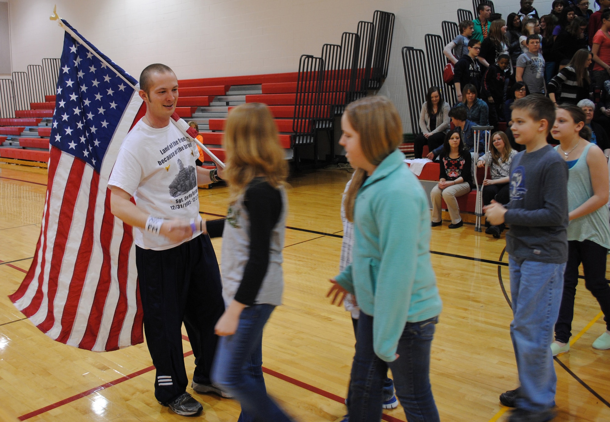 Kurt Philion greets audience members after delivering a speech about how the death of his friend, an Army sergeant, inspires him to keep running marathons and other races during a March 25, 2013, visit at to Nathan Twining Elementary on Grand Forks Air Force Base, N.D. Philion runs in competitive races in memory of his friend, Sgt. Corey Rystad, who was killed in Iraq in 2006. (U.S. Air Force photo/Staff Sgt. Luis Loza Gutierrez)