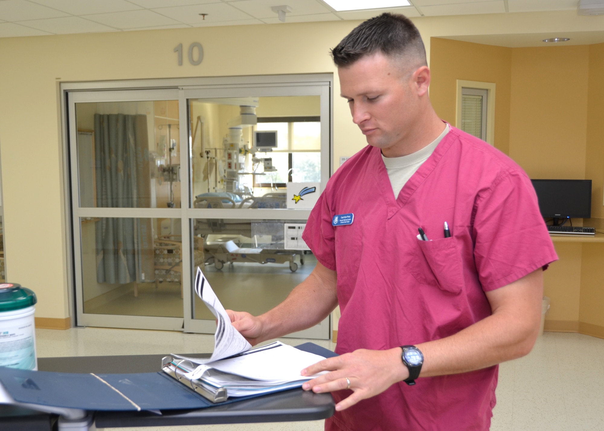 Capt. Kyle Perry, 81st Inpatient Operations Squadron, reviews a patient’s chart at the Intensive Care Unit nurses’ station March 6, 2013, at the Keesler Medical Center, Keesler Air Force Base, Miss. Perry was selected to be part of the White House clinic and reports in October for a three-year assignment. (U.S. Air Force photo by Steve Pivnick)