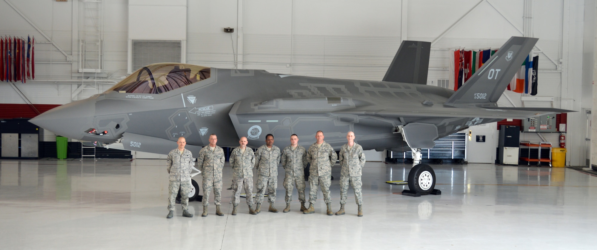 From left, 914th Logistics Readiness Squadron members Senior Master Sgt. Doni Henry, Tech. Sgt. Joseph Foucha, Tech. Sgt. Mark Loughrey, Tech. Sgt. Jerry Evans, Staff Sgt. Lyle Szpakowski, Tech. Sgt. Ronald Smith, and Staff Sgt. Jason Borghi pose in front of an F-35 Lightning II at Nellis Air Force Base, Nev. March 14-21, 2013.  These Airmen from the Niagara Falls Air Reserve Station, N.Y. completed more than a week of extensive training in their respective AFSCs.  (U.S. Air Force courtesy photo)