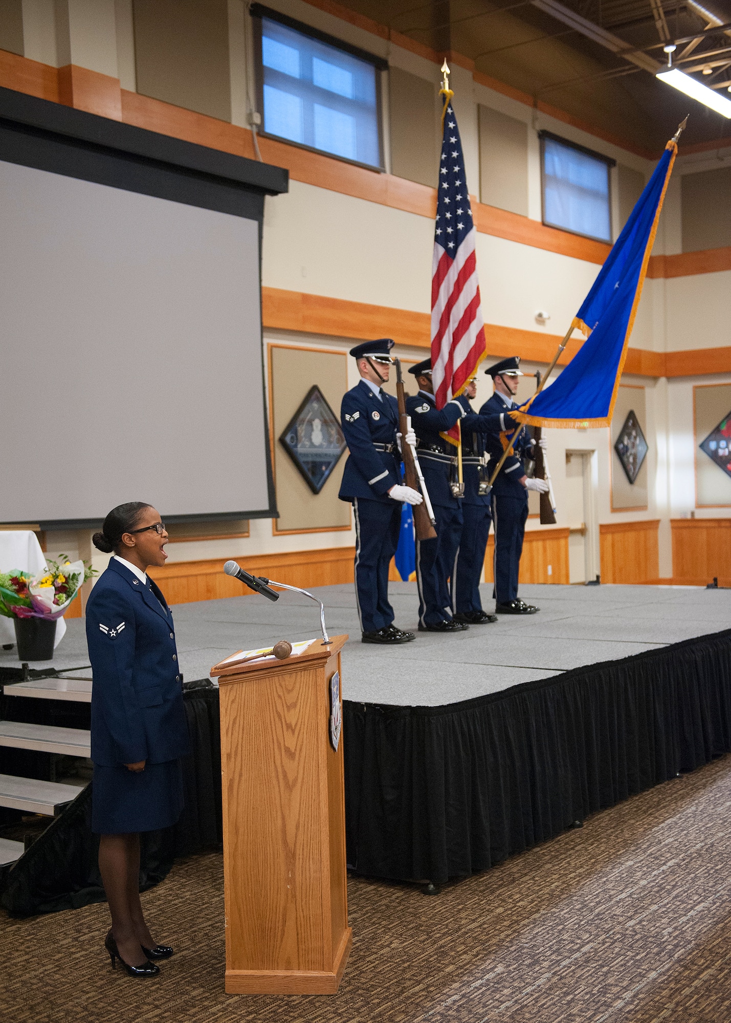 Airman 1st Class Christina Arrington- Silva, 341st Medical Operations Squadron medical technician, sings the national anthem at the Team Malmstrom Chief’s Recognition Banquet at the Grizzly Bend on March 22. Malmstrom’s honor guard presented the colors in the background. (U.S. Air Force photo / Beau Wade)
