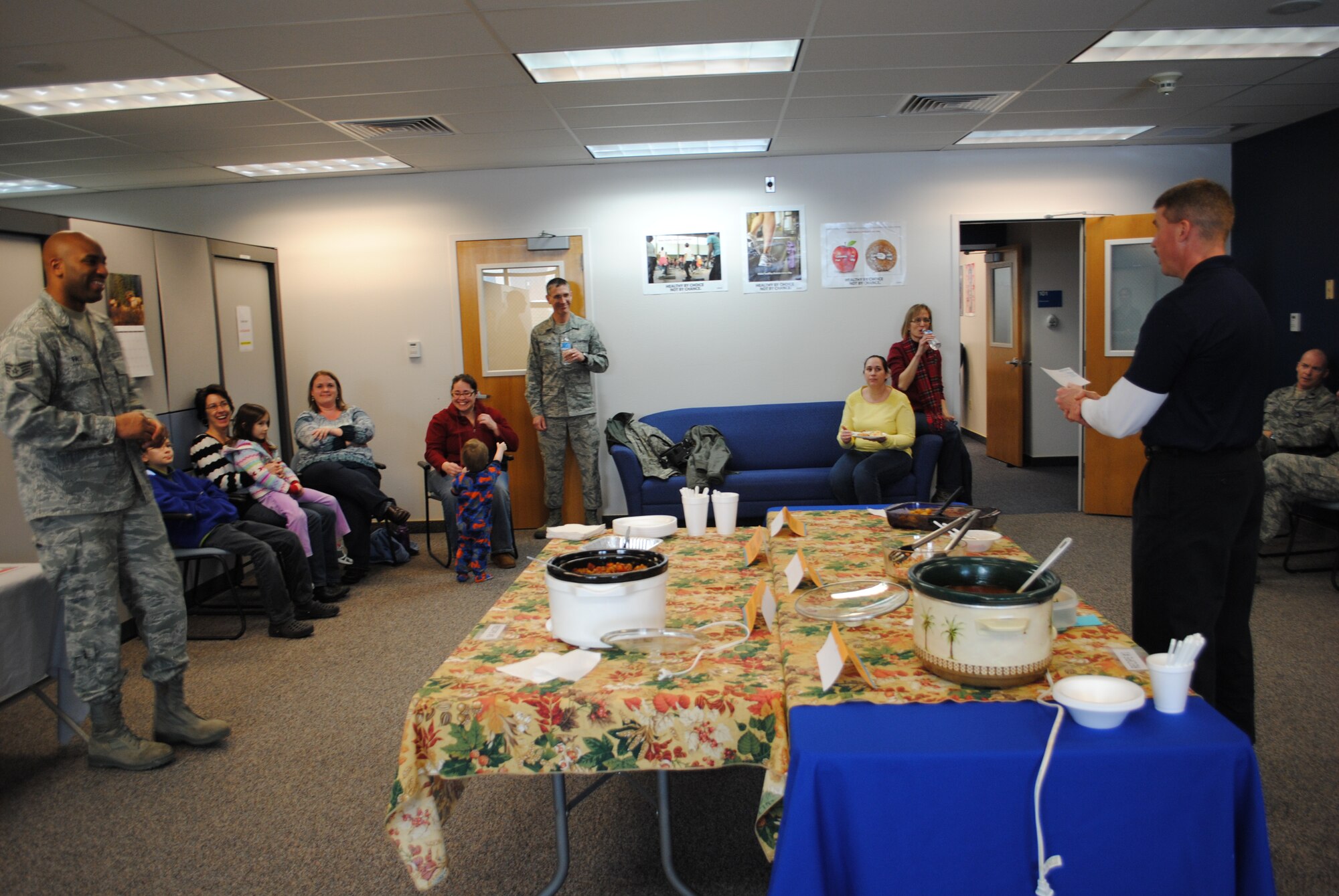 Kirk Clark, 341st Medical Group Health and Wellness Center exercise physiologist, right, announces the top three winners in the HAWC’s “Eat Right, Your Way, Every Day” Recipe Challenge on March 22.  The winning dish was a Chicken Tortilla soup prepared by Lisa Broussard; wife of Tech. Sgt. Christian Broussard, 341st Logistics Readiness Squadron unit deployment manager.  (U.S. Air Force photo/Senior Airman Cortney Paxton)