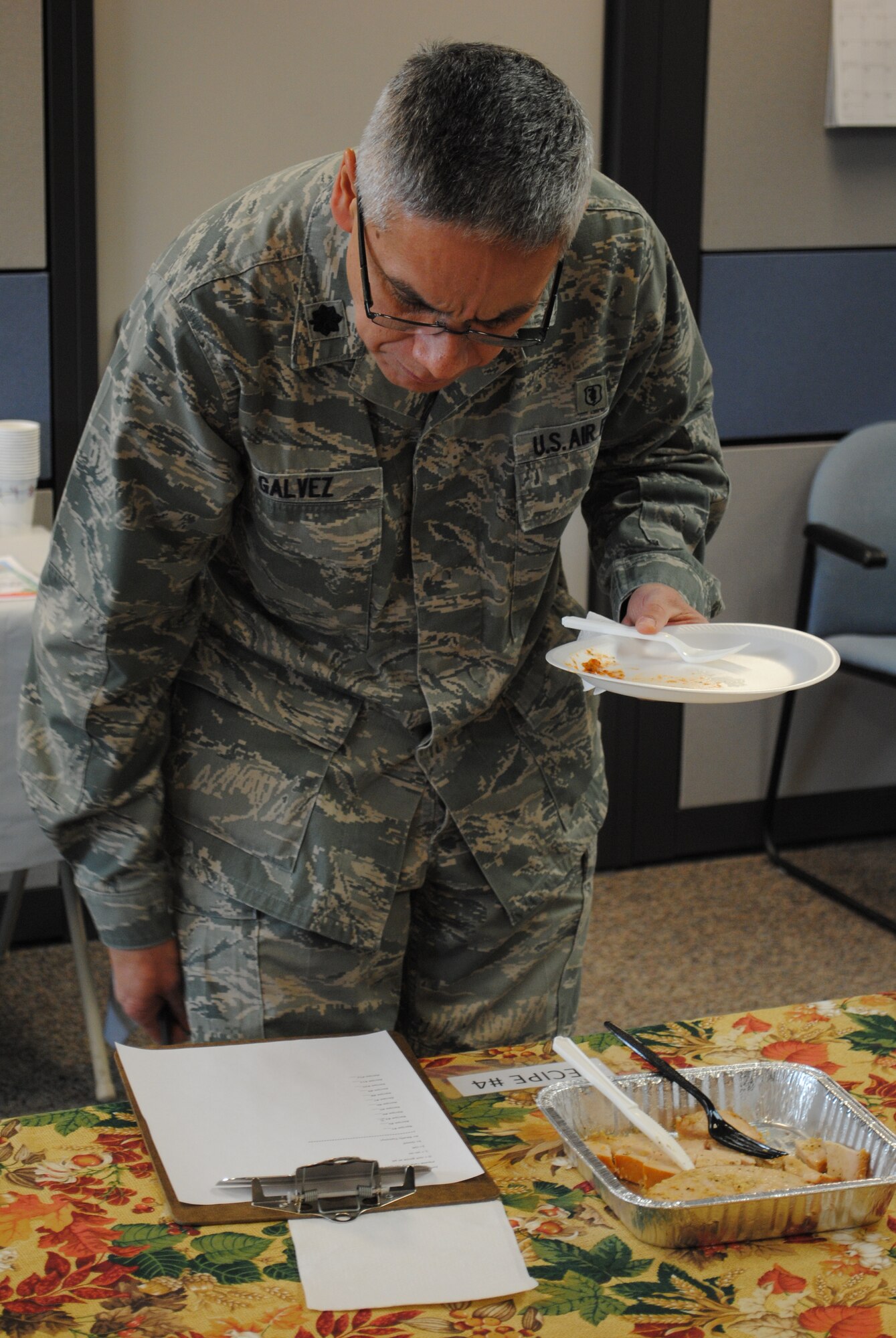 Lt. Col. Marco Galvez, 341st Medical Operations Squadron member, looks at the judging criteria after tasting one of five recipes entered in the “Eat Right, Your Way, Every Day” Recipe Challenge at the Health and Wellness Center on March 22.  The recipes entered were required to be a healthy entrée that could be made in 30 minutes or less, and have less than 500 calories, five grams of saturated fat and 500 milligrams per serving.  (U.S. Air Force photo/Senior Airman Cortney Paxton)
