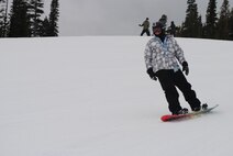 Tech. Sgt. Martin Edwards, 341st Logistics Readiness Squadron heavy equipment maintenance NCO in charge, snowboards down Sour Dough Hill Trail during Malmstrom’s final Wing Ski Day of the season at Showdown Ski Resort on March 20. Airmen participated in several activities including snowboarding, skiing and snowshoeing. (U.S. Air Force photo/Airman 1st Class Katrina Heikkinen) 