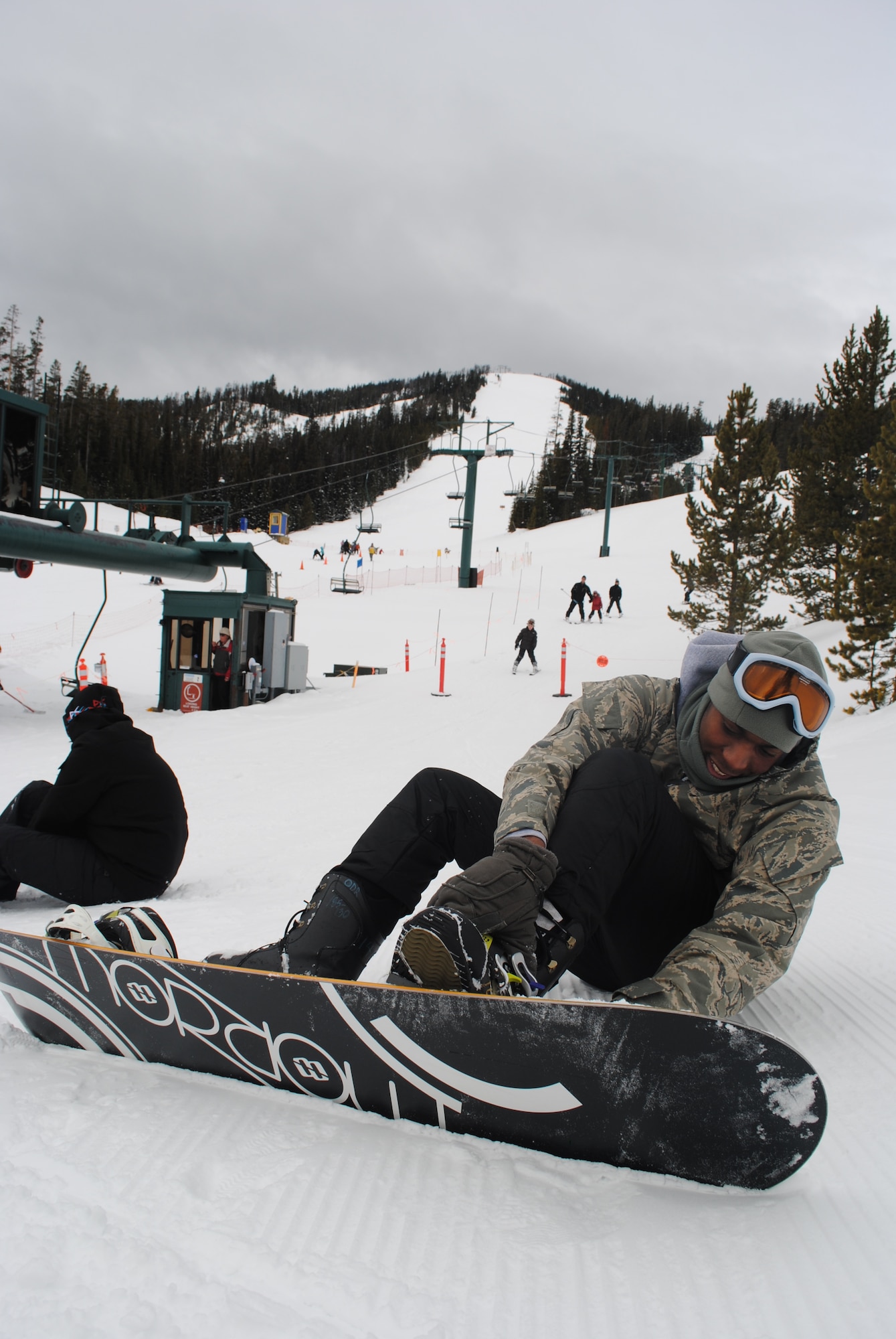 Airman 1st Class Tre Boomer, 341st Logistics Readiness Squadron member, adjusts his snowboard bindings at Showdown Ski Resort on March 20. Malmstrom Air Force Base provided free transportation to and from the resort as well as equipment during the Wing Ski Day event. (U.S. Air Force photo/Airman 1st Class Katrina Heikkinen)