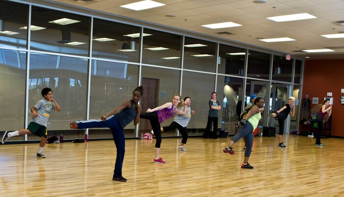Members of the Nellis community participate in Body Combat, a cardio workout drawing from a variety of martial arts disciplines, at the Warrior Fitness Center March 24, 2013, at Nellis Air Force Base, Nev. Body Combat is an energetic workout program inspired by mixed martial arts. (U.S. Air Force photo by Senior Airman Matthew Lancaster)