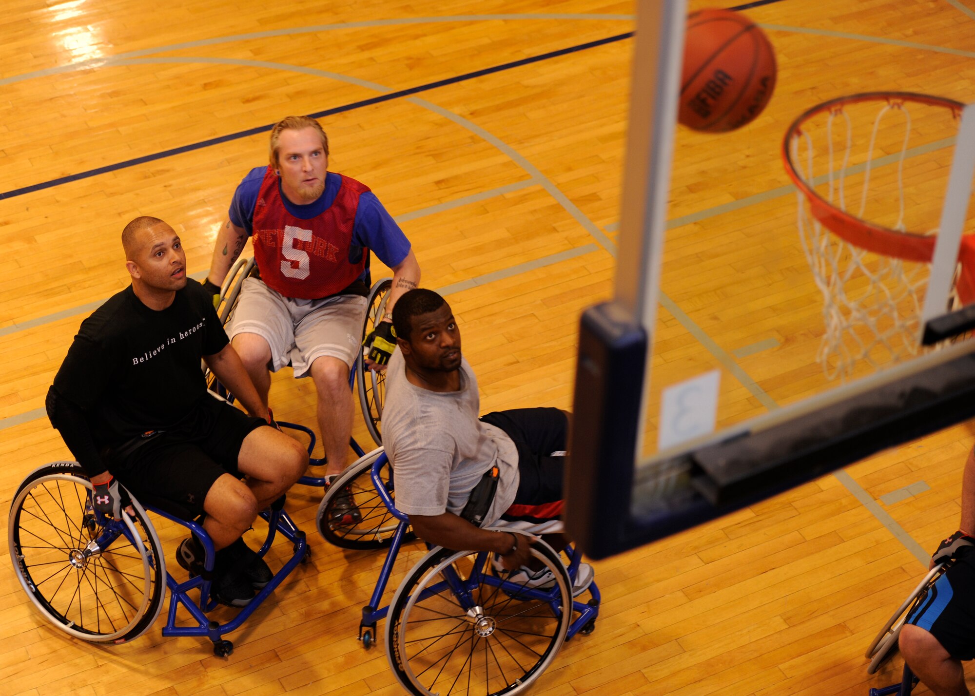 U.S. Air Force members play wheelchair basketball during an Air Force Adaptive Sports Program camp at the Rambler Fitness Center on Joint Base San Antonio-Randolph, Texas, March 22, 2013. The goal of the Air Force Wounded Warrior Adaptive Sports program is to introduce adaptive sports early on in the healing process in order to promote physical, social, emotional and spiritual healing. (U.S. Air Force photo/Airman 1st Class Westin Warburton)

