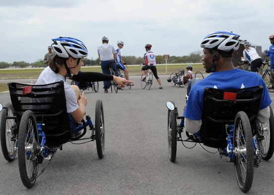 U.S. Air Force Staff Sgt. Lara Ishikawa, 359th Medical Wing, explains the functions of a recumbent bike during an Adaptive Sports Program camp at Joint Base San Antonio-Randolph, Texas, March 21, 2013. The goal of the Air Force Wounded Warrior Adaptive Sports program is to introduce adaptive sports early on in the healing process in order to promote physical, social, emotional and spiritual healing. (U.S. Air Force photo/Airman 1st Class Westin Warburton)