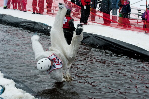 JOINT BASE ELMENDORF-RICHARDSON, Alaska -- Mark Drake, dressed as a yeti, dives back into the pond at the Hillberg Ski Area Slush Cup March 24. During the Slush Cup contestants had the opportunity to swim in the icy lake water.  The Hillberg Ski Area Slush Cup is an event where contestants can ski or snowboard across a man made pool to the end for prizes.  (U.S. Air Force photo/Airman 1st Class Omari Bernard)