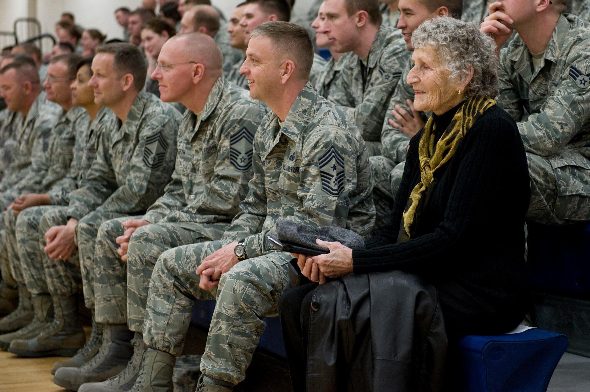 Kathleen McCoy, wife of retired Chief Master Sgt. of the Air Force James M. McCoy, sits next to Chief Master Sgt. William Ward, 460th Space Wing command chief, at an enlisted call March 26, 2013, at Buckley Air Force Base, Colo. McCoy traveled with her husband who has given speeches across the Air Force encouraging Airmen during the difficult times caused by sequestration. (U.S. Air Force photo by Senior Airman Phillip Houk/Released)