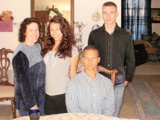 (Left to right) Tech. Sgt. Katherine Edgar, 844th Communication Group training manager, Victoria Edgar, Senior Master Sgt. Edward Edgar, 319th Recruiting Squadron production superintendent and Airman 1st Class Ashton Spurr, 11th Logistics Readiness Squadron logistics planner, pose for a family photograph thanksgiving day at their home Nov. 22, 2012. (Courtesy photo)